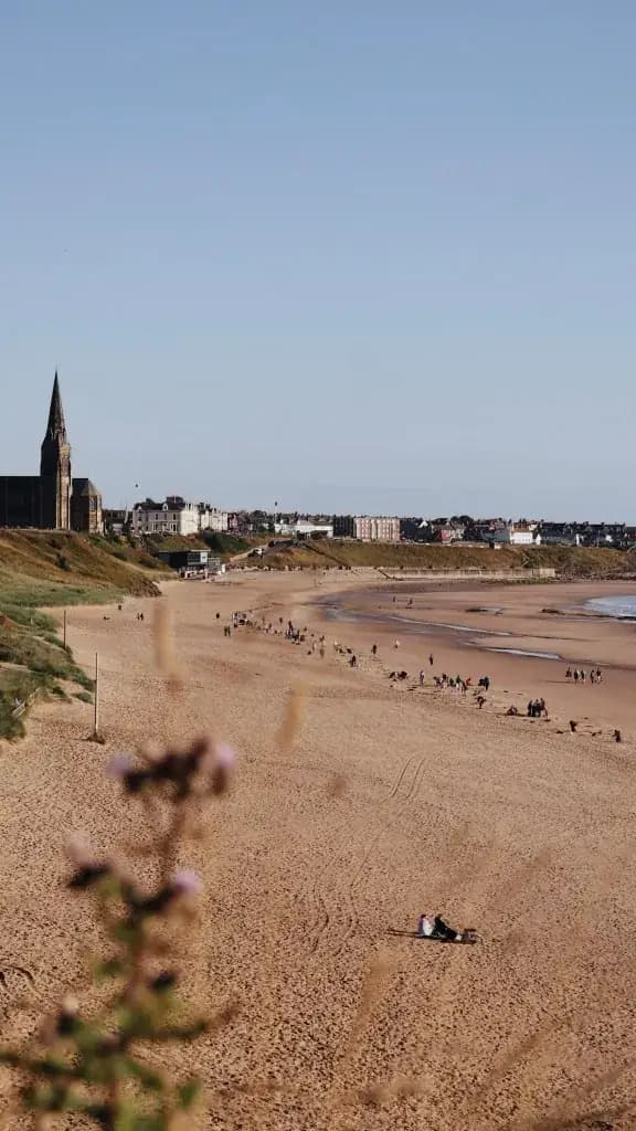 Elevated view of volunteers on the beach with St George’s Church on the cliff